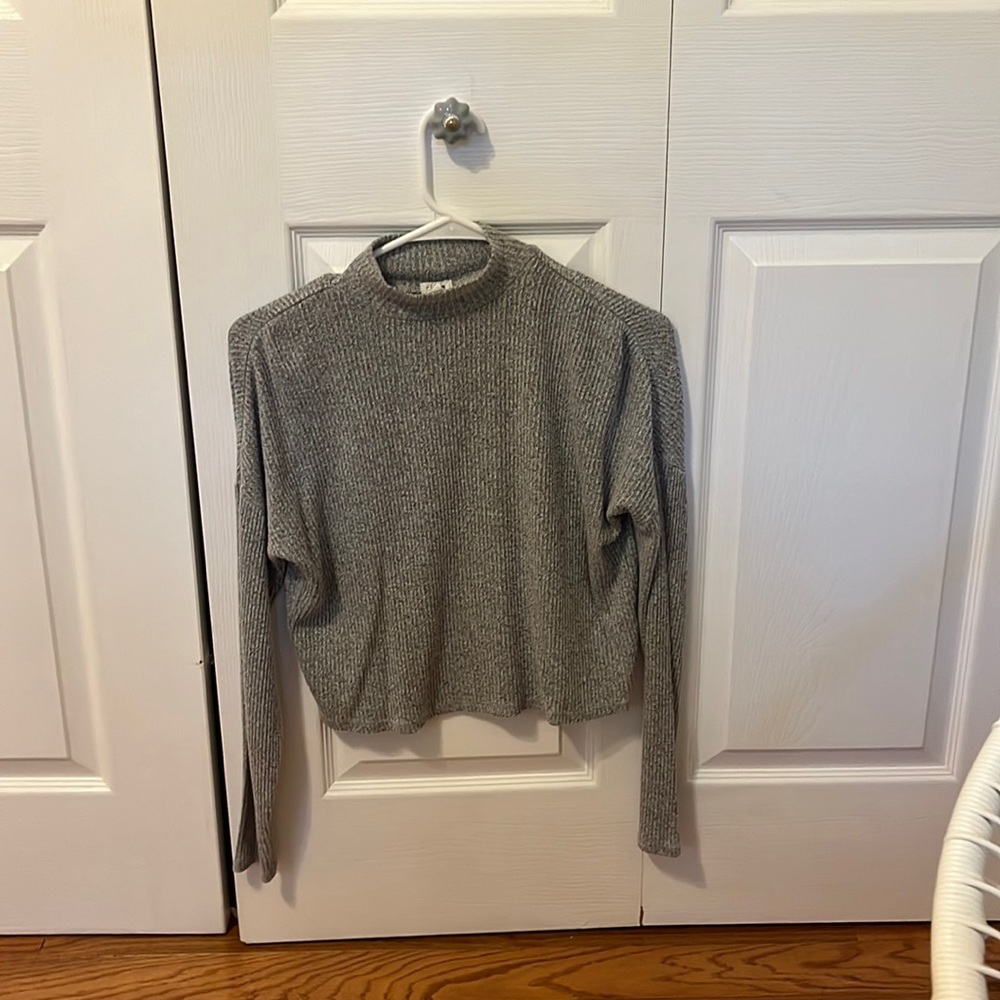 This turtle neck is from garage, is a size XS, and comes in grey.